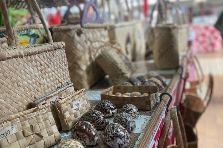 Woven baskets, a display of patterned eggs, and a wooden table. 3