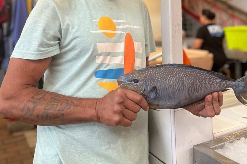 A person holding a fish. 4