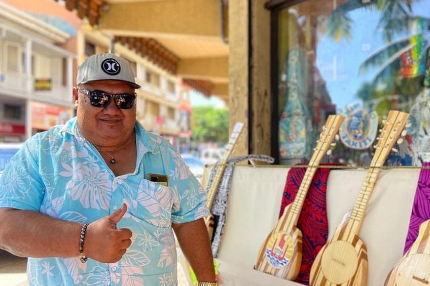 A person standing in front of a display of wooden instruments. 2