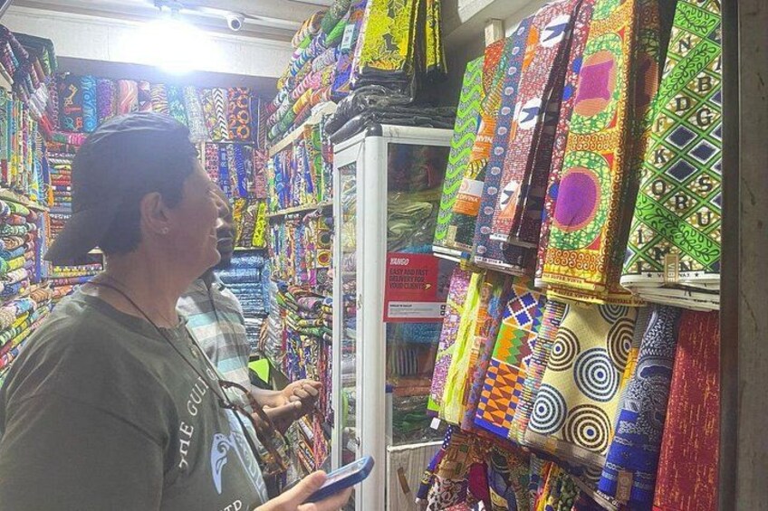 A person browsing colorful fabrics in a store. 5