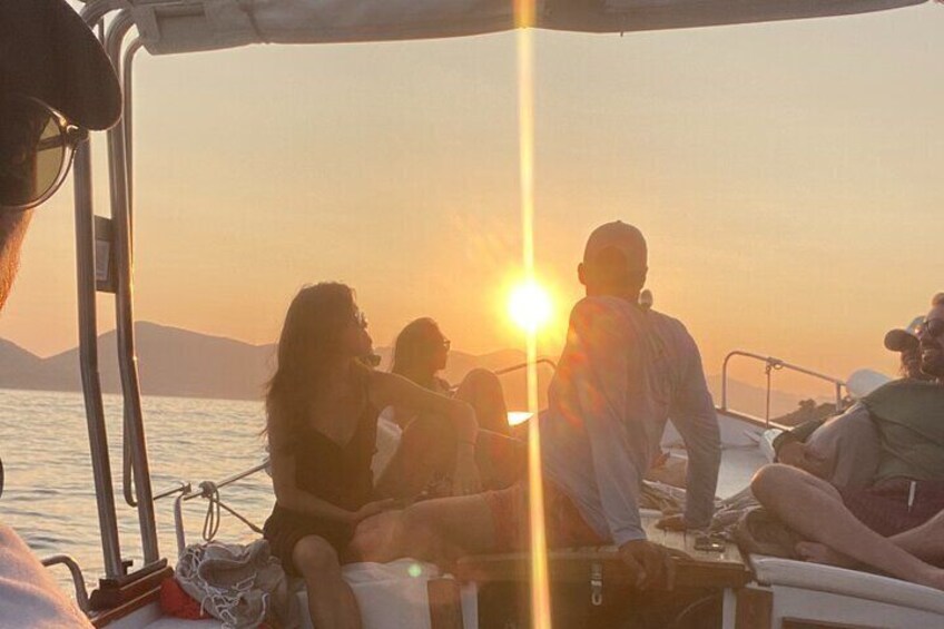A group of people on a boat during sunset. 3