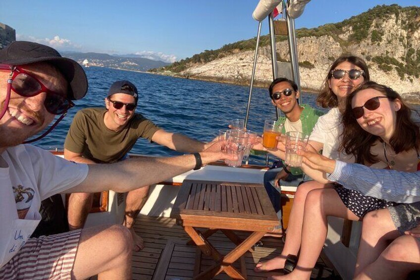 A group of people on a boat, toasting with drinks. 4