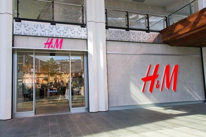 The exterior of an H&M store with large signage and a glass entrance. 1