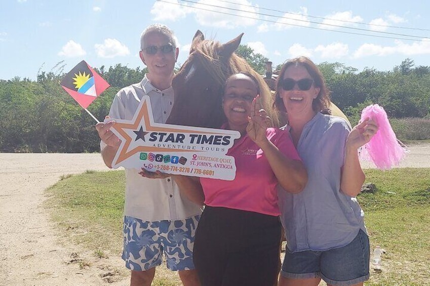 Three people holding a sign with a star and a flag. 3