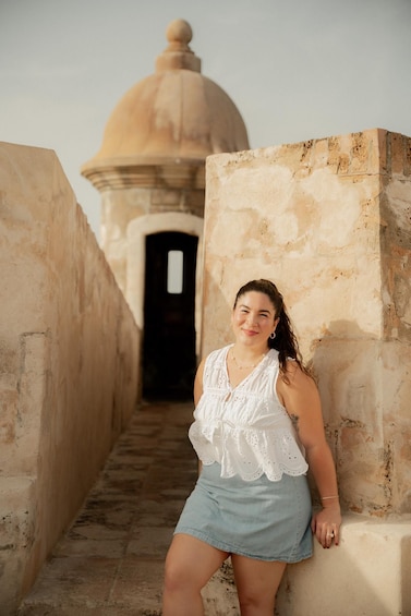 A person standing in a narrow alleyway with a domed building in the background. 2