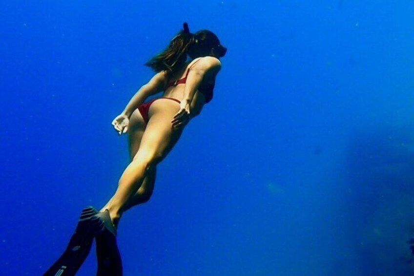 A person swimming underwater. 1