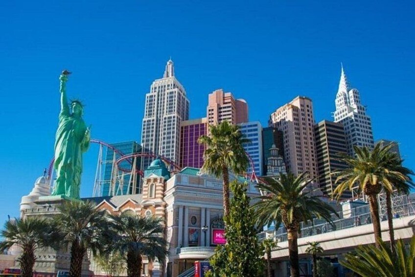The Las Vegas skyline with the Statue of Liberty, a casino, and palm trees. 4