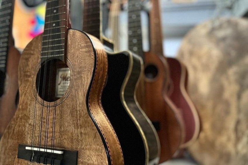 A collection of ukuleles with a wooden body and a soundhole. 2
