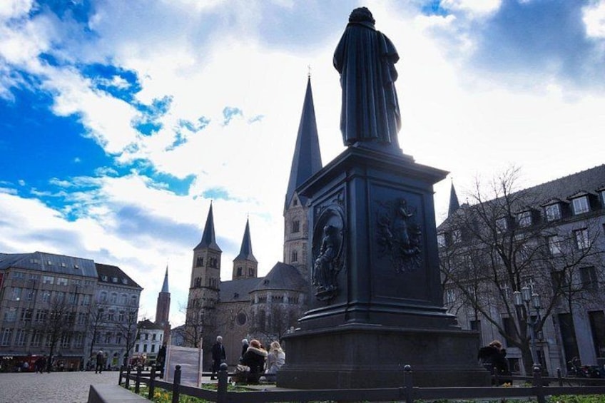 A statue in a square with a church in the background. 5