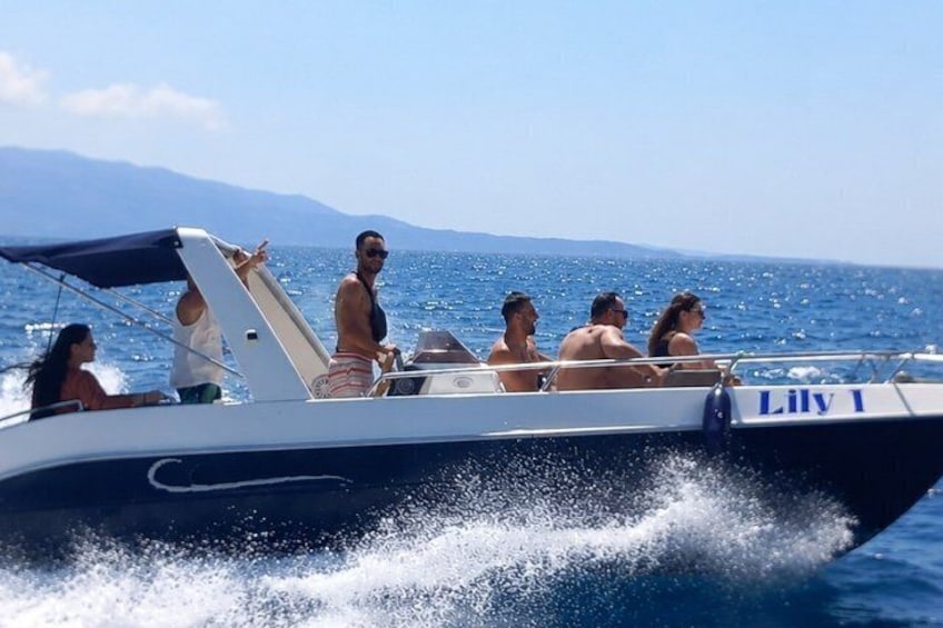 A boat named 'Lily 1' with passengers enjoying a sunny day on the water. 4