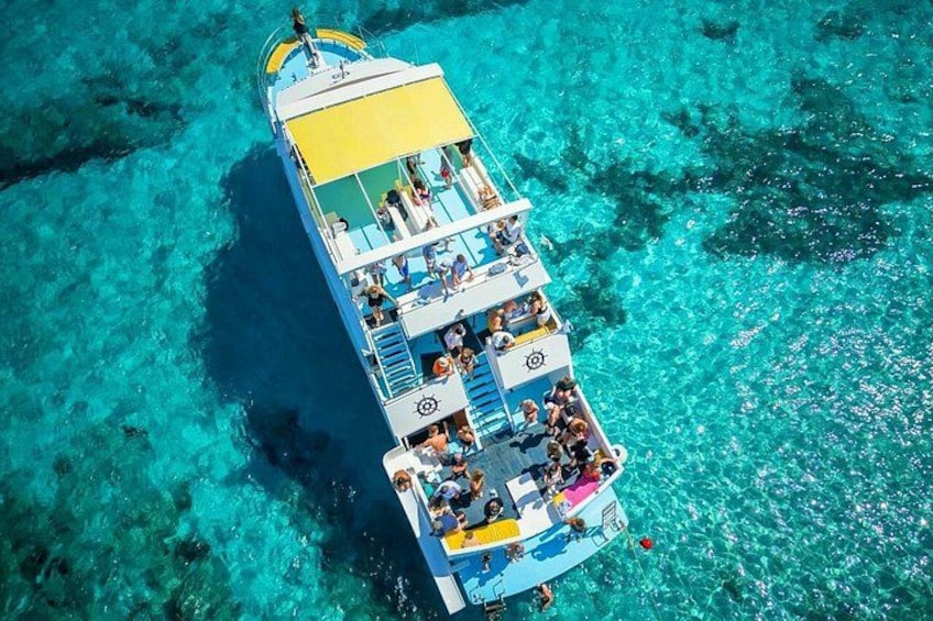 A boat with passengers on a clear turquoise sea. 2