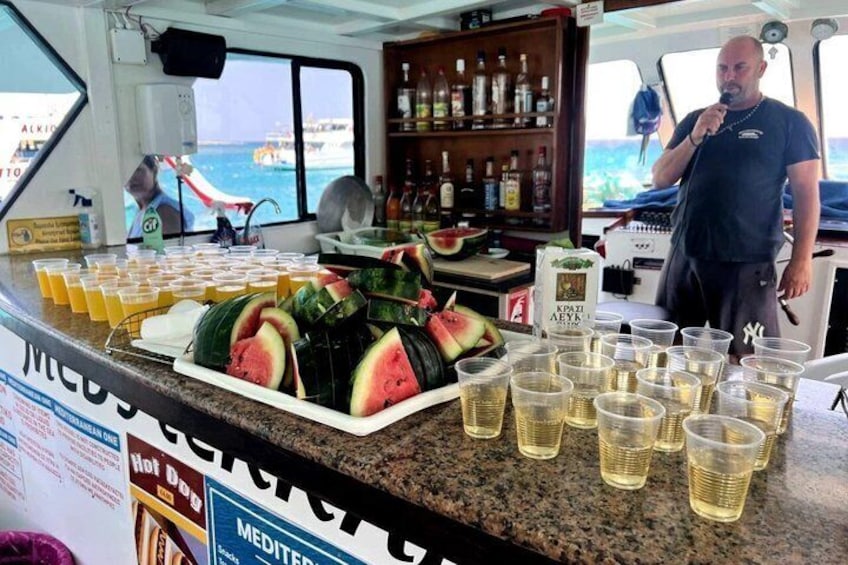A bar area on a boat with a counter displaying watermelon slices and shot glasses. 5