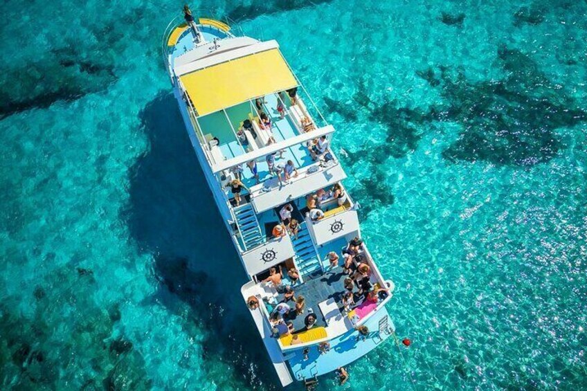 A boat with passengers, surrounded by clear turquoise water. 2