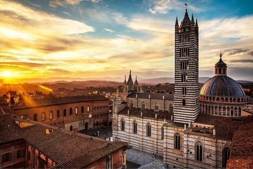 A historic cityscape with a prominent tower, a dome, and a cathedral. 2