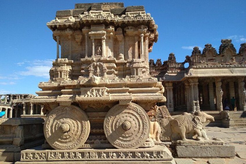 A stone temple with intricate carvings and a lion statue. 3