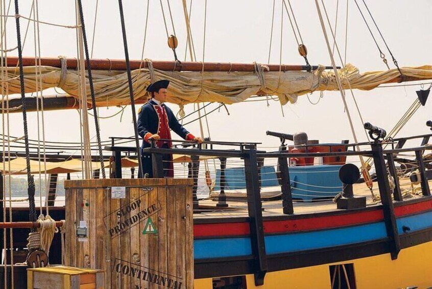 A person standing on a ship deck with ropes and a wooden crate labeled "Continental." 1