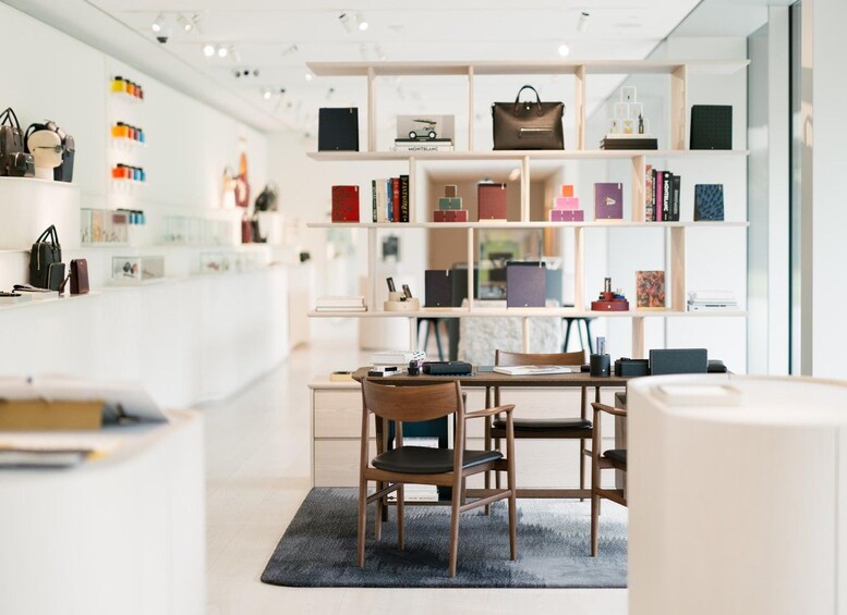 A modern interior with a desk, chairs, and a bookshelf filled with books and decorative items. 3