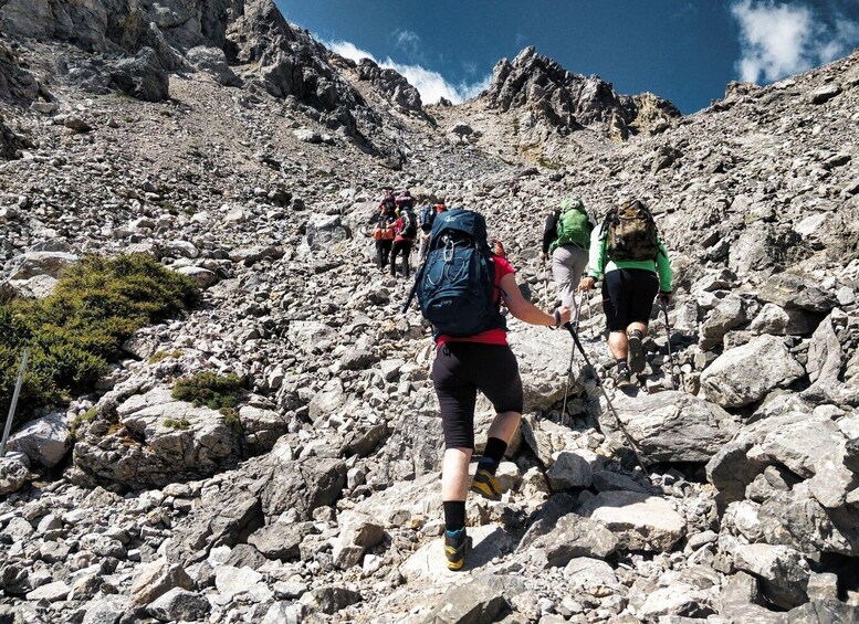 Hikers ascending a rocky mountain trail. 5