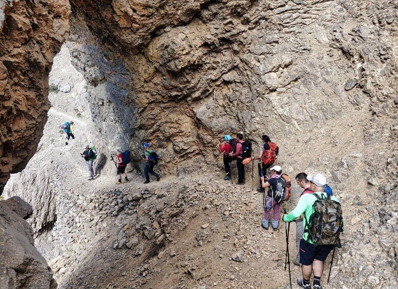 A group of hikers ascending a rocky mountain path. 3