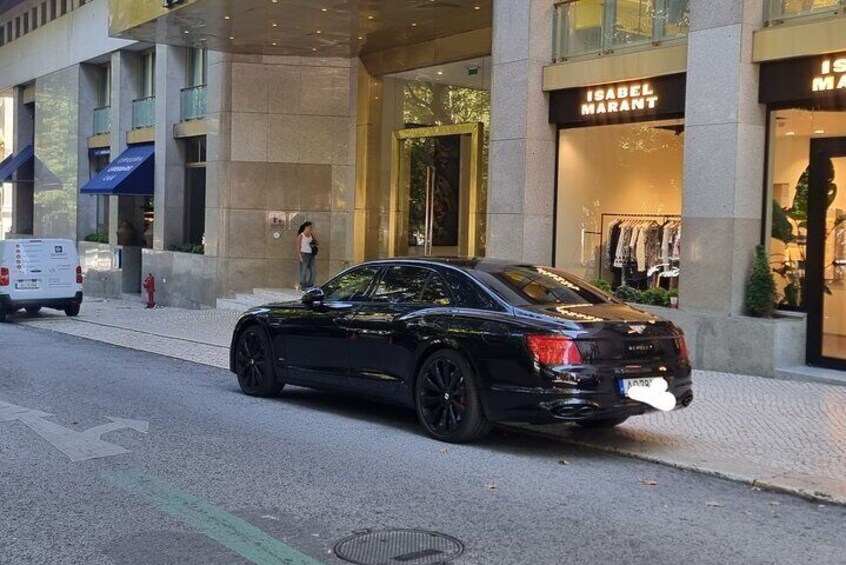 A black car parked on a city street in front of a building with a storefront named "Isabel Marant". 3