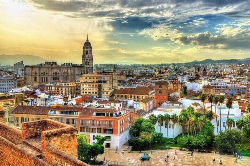 A cityscape with historic buildings, a prominent clock tower, and a clear sky. 3