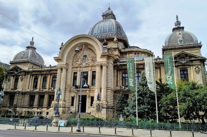 A historic building with domed architecture and flags. 3