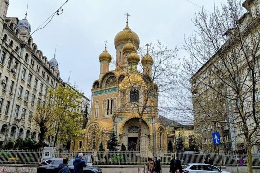 A historic church with multiple golden domes and a traditional facade. 2