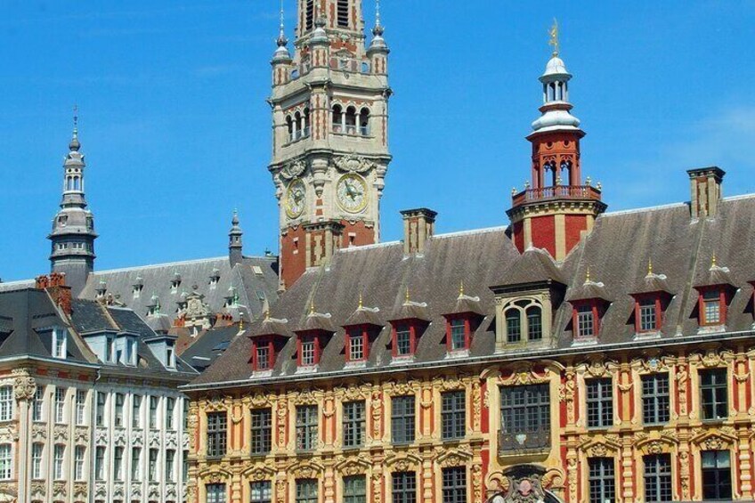 A historic building with ornate architecture, a prominent clock tower, and a red-roofed tower. 5