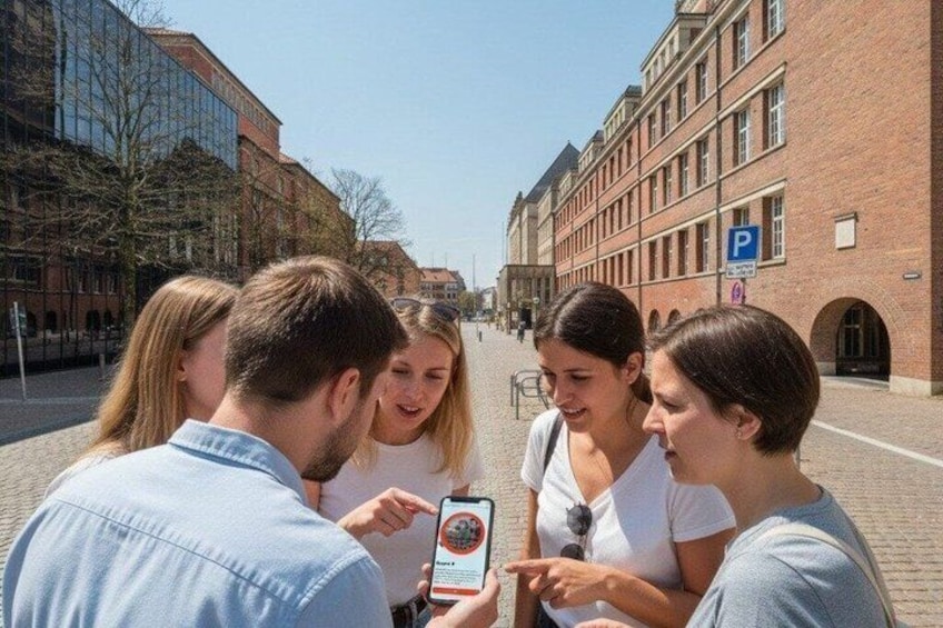 A group of people standing on a street with buildings and a clear sky. 2