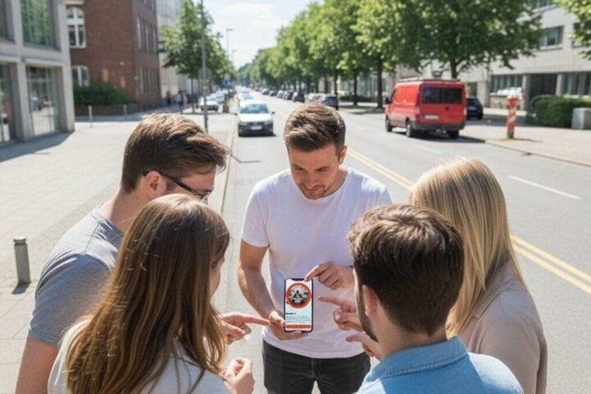 A group of people standing on a city street, looking at a smartphone. 3