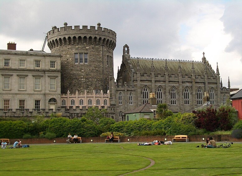 A castle with a round tower and a large building with pointed arches. 5