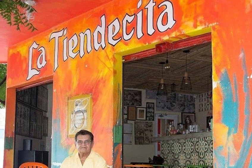 A colorful building with a sign reading 'La Tiendectica.' 4