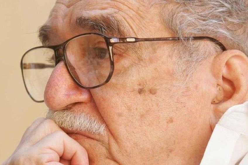 A person with glasses and a white shirt. 1