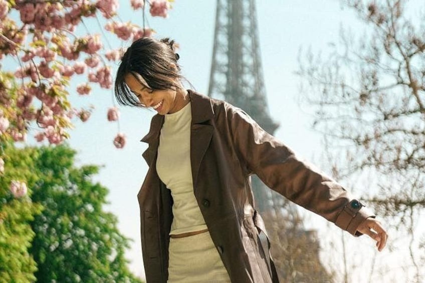 A person in a coat with the Eiffel Tower in the background. 3