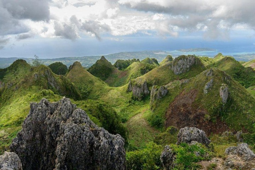 A mountainous landscape with green vegetation and rocky outcrops. 1