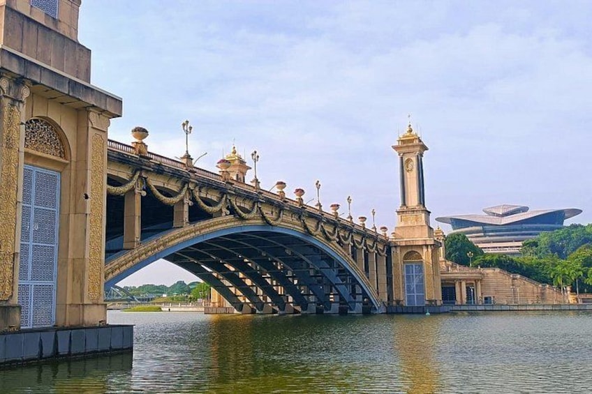 A bridge with ornate railings and a clock tower, spanning a body of water. 4