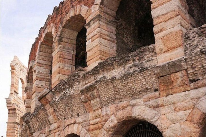 Ancient stone architecture with arches and a weathered facade. 3