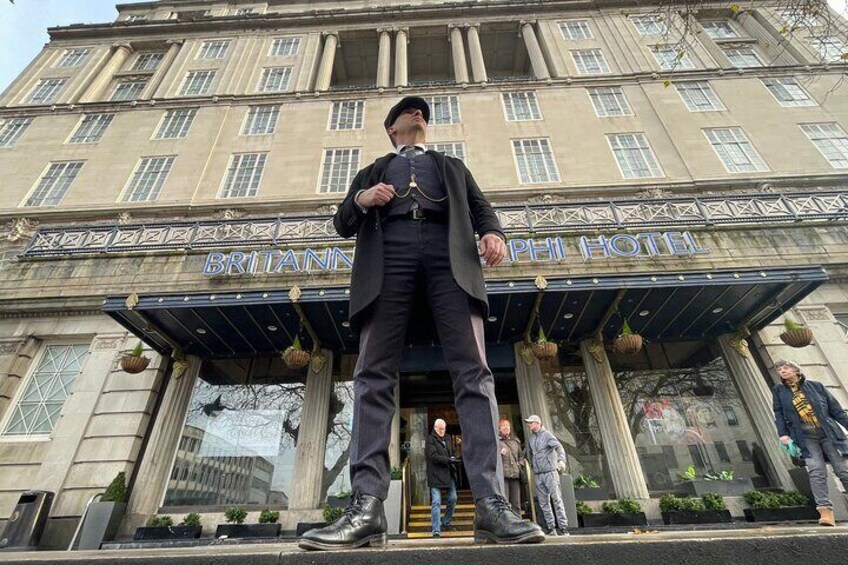 A person standing in front of the Britannia Hotel. 2