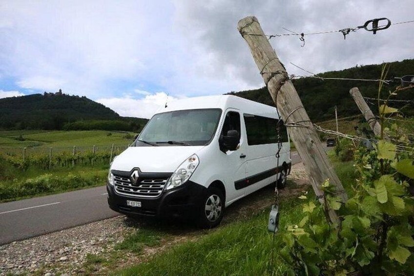 A white van parked on a rural road with a wooden fence leaning against it. 3