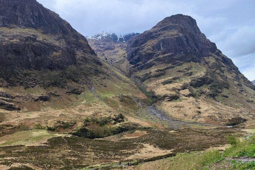 A mountainous landscape with rocky terrain and sparse vegetation. 5