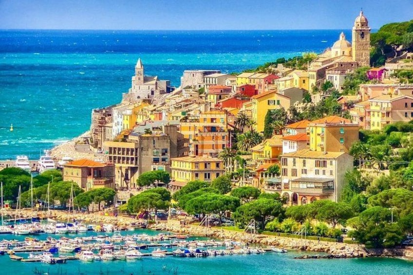 A coastal town with colorful buildings, a marina, and the sea. 3