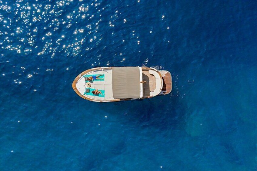 An aerial view of a boat with a deck and two people. 1