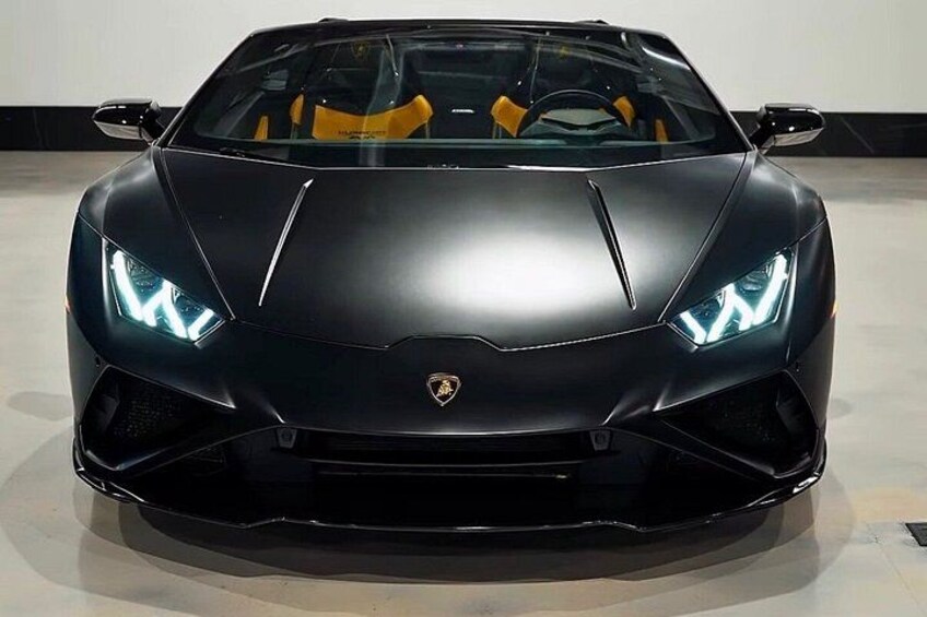 A black sports car with distinctive headlights and a visible emblem on the front. 3