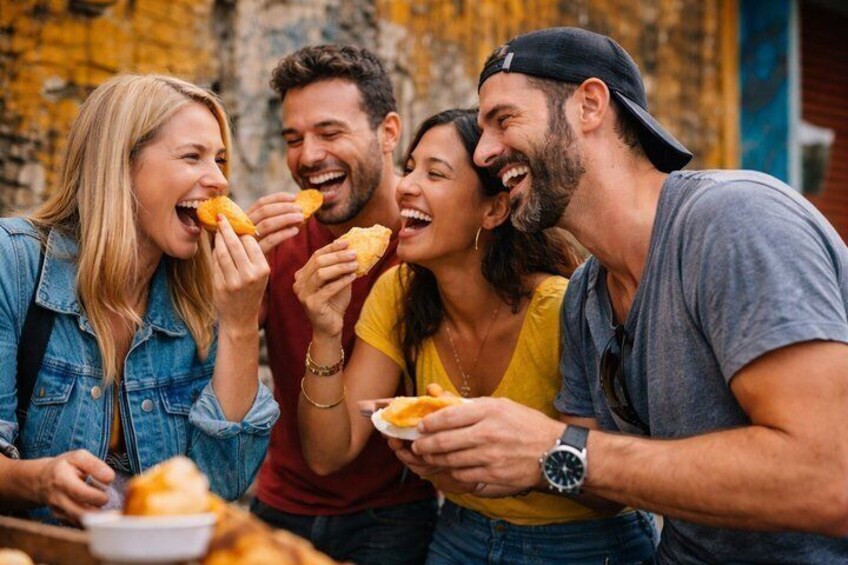 Four people eating food at an outdoor table. 4