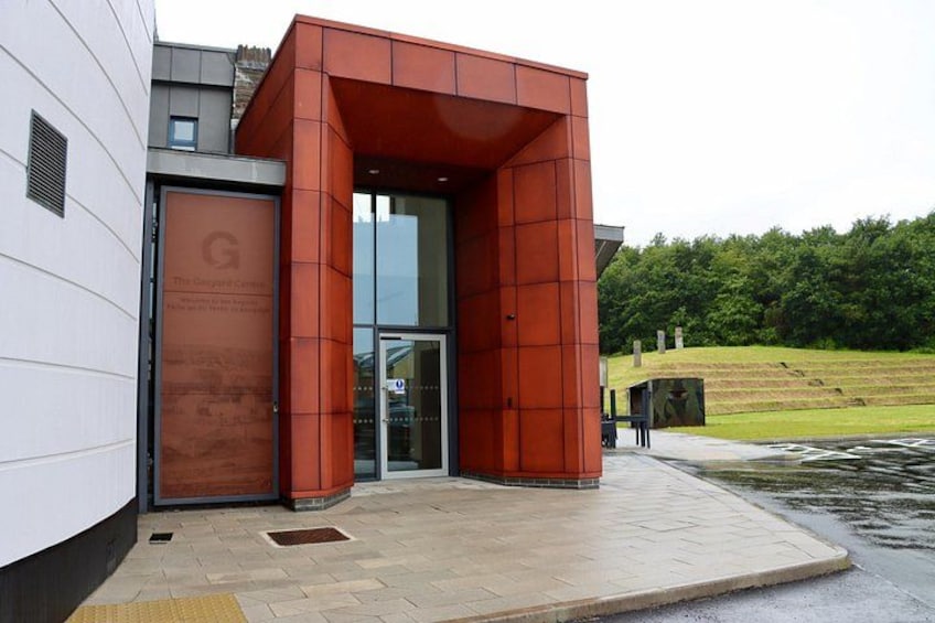 A modern building with a red-brick entrance and a glass door. 4