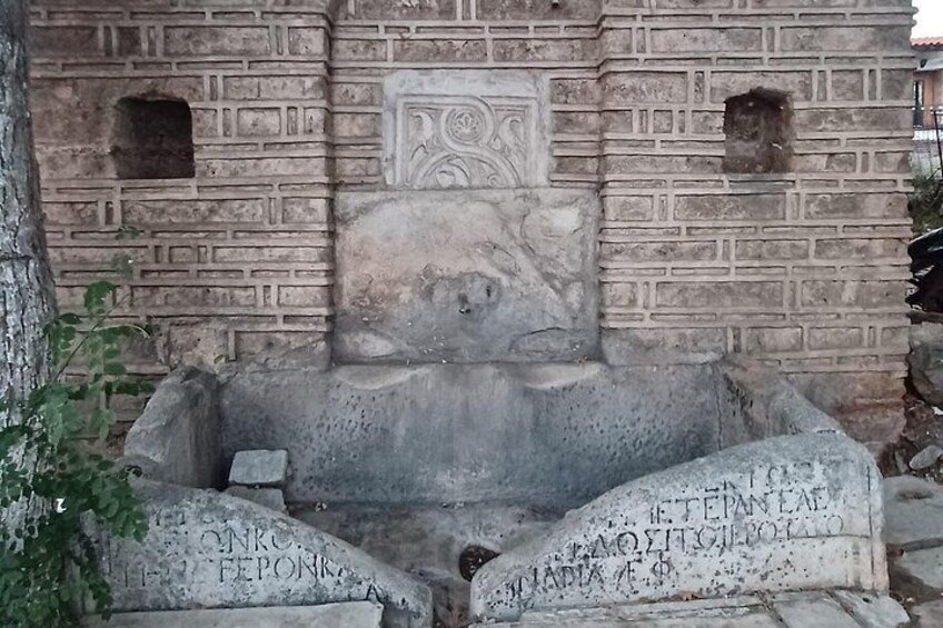 An ancient stone structure with carvings and inscriptions. 4