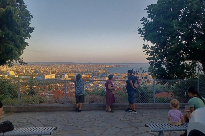 A group of people overlooking a cityscape from a high vantage point. 5