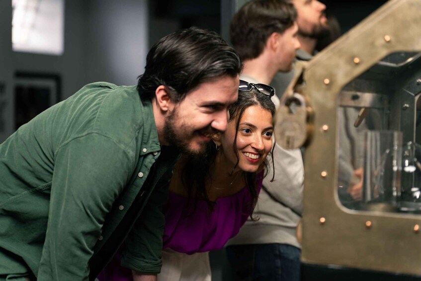 A group of people looking at a vintage vehicle. 5