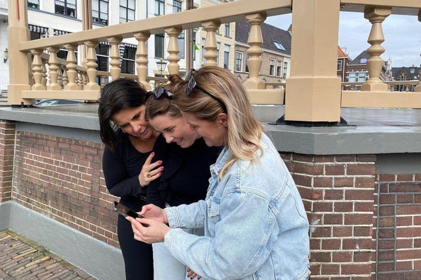 Three people standing on a brick wall with a balustrade in the background. 4