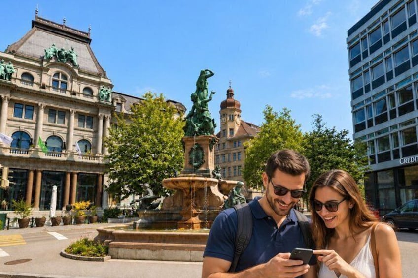 A couple standing in front of a historic building with a fountain. 4
